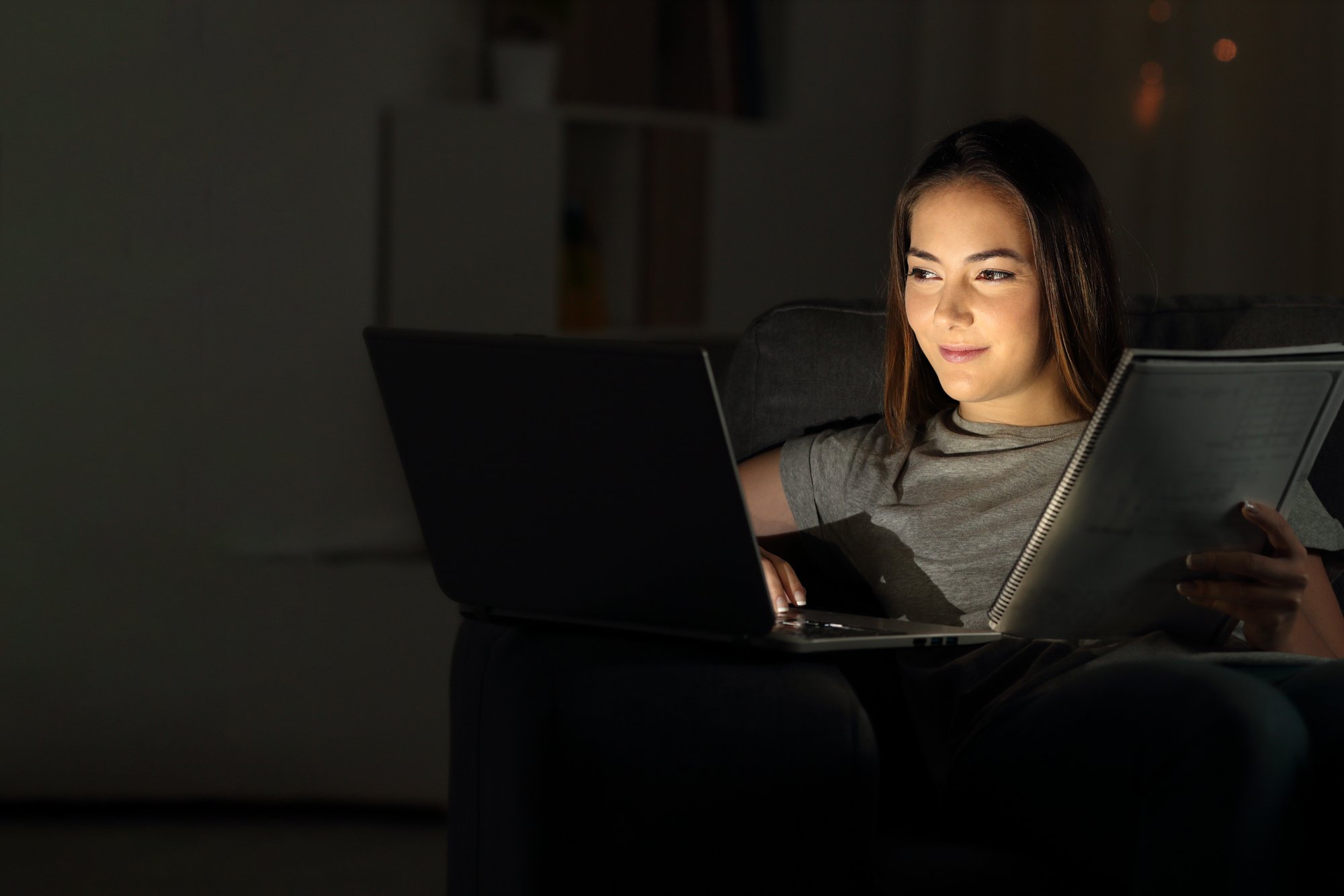 Student-studying-evening-laptop-book