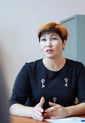 School-principal-talks-at-desk