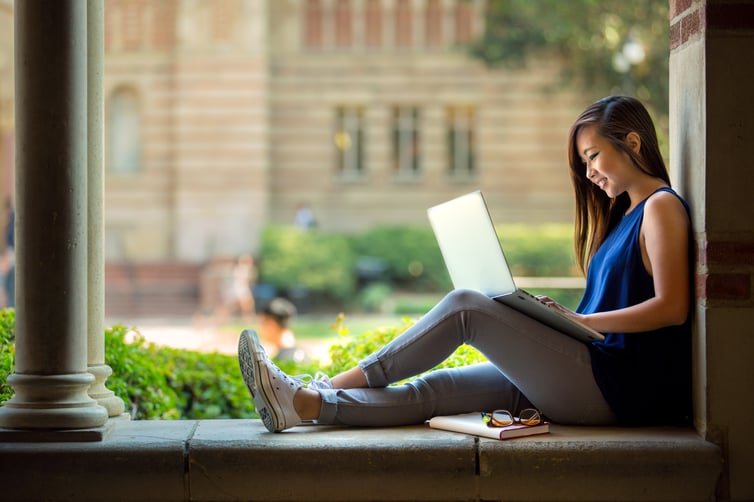 Young-woman-tertiary-student-sitting-campus.jpeg