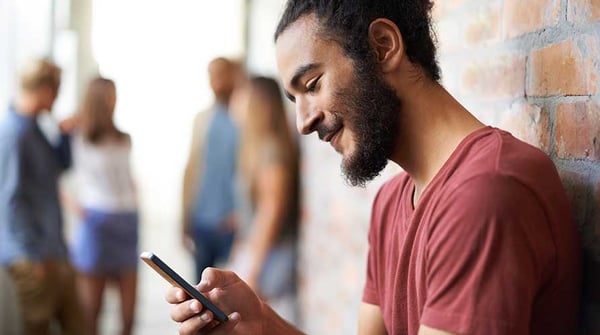 Tertiary-student-uses-his-phone-for-online-tutoring