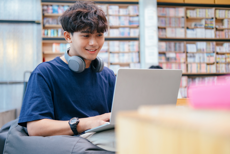 Male student studying in library